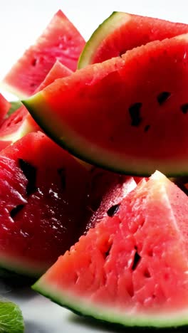 fresh watermelon slices arranged creatively on a white surface