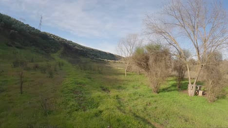 A-campsite-in-the-countryside-of-Andalusia,-Spain-basks-in-the-afternoon-sun-in-an-aerial-drone-shot