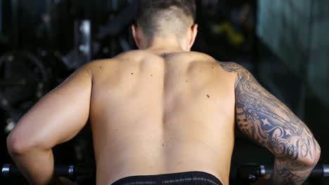 strong sportsman muscular athlete doing weightlifting exercises at modern gym, showcasing the beauty bodybuilder, power of body, strength and endurance