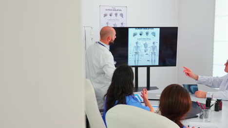 medical scientins analysing digital human skeleton model