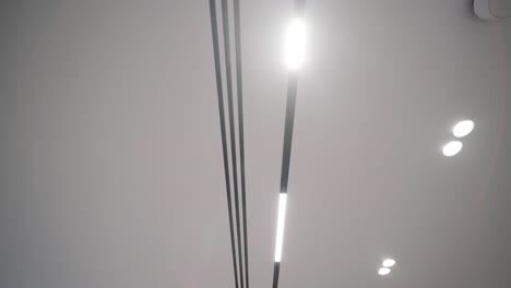 ceiling view showcasing the contrast of sleek, modern led strips and traditional spotlights in a contemporary interior