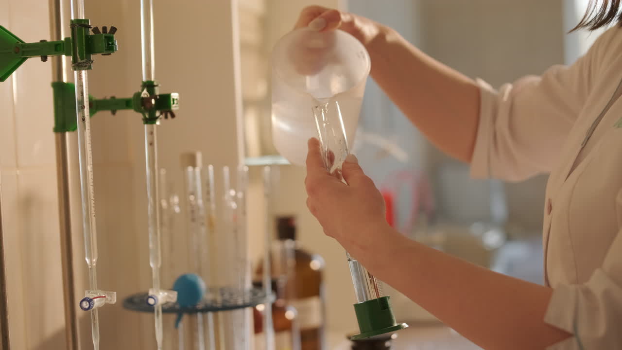 Scientist Pouring Liquid in Lab