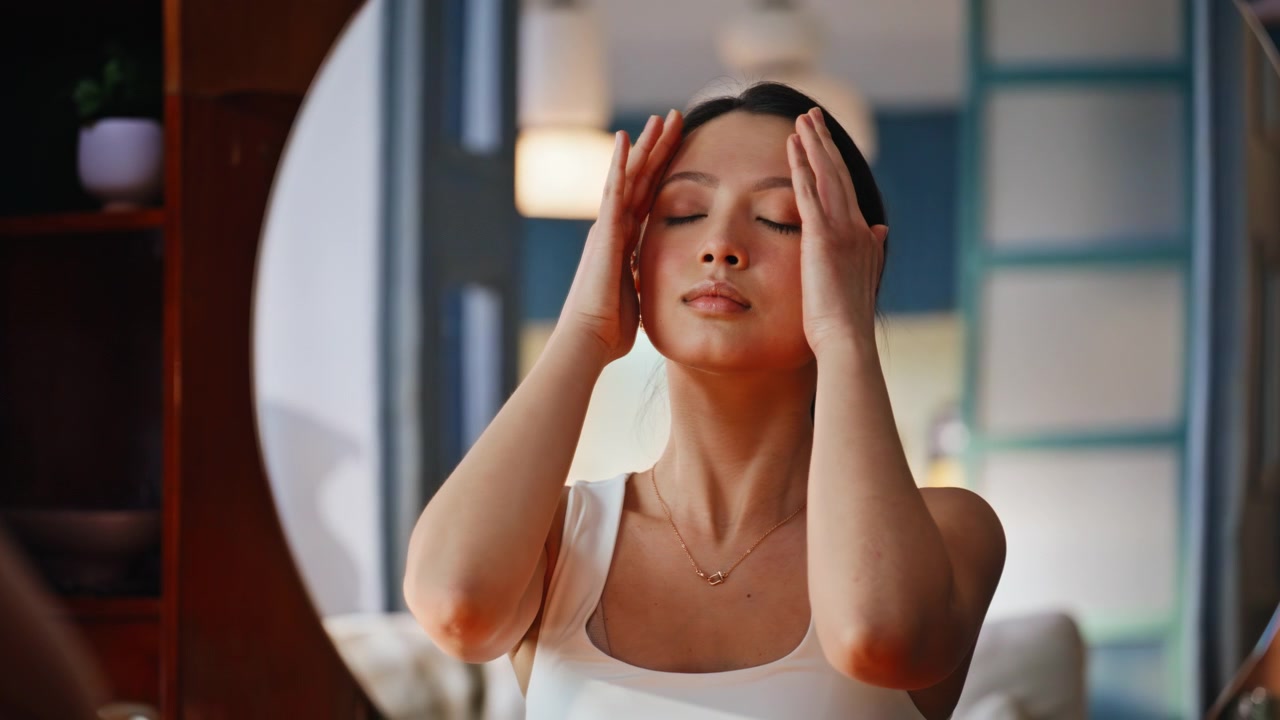 Facial massage woman doing face yoga home. Close up portrait skincare routine.