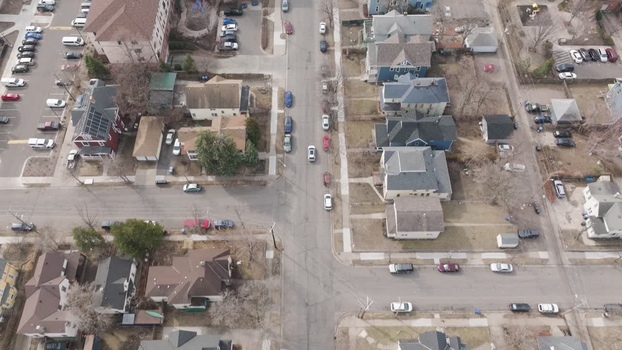 Drone view of cars moving through quiet residential streets in Minneapolis.