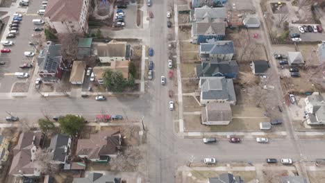 drone view of cars moving through quiet residential streets in minneapolis.