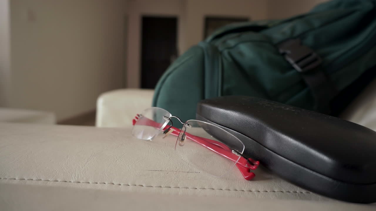 Wide shot of a pair of prescription glasses with red legs