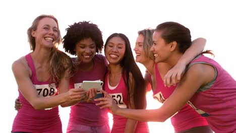 runners supporting breast cancer marathon and taking selfies