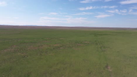 Moving-drone-shot-over-open-farmland