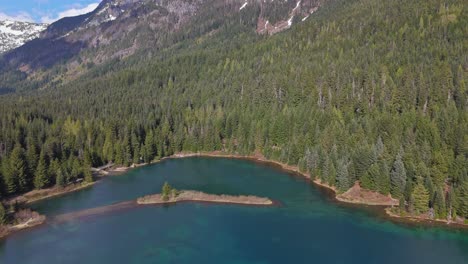 Aerial-view-of-Gold-Creek-Pond-with-Evergreen-forest-and-mountain-in-the-background-in-Washington-State