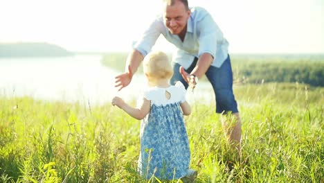 father helping daughter learn to walk