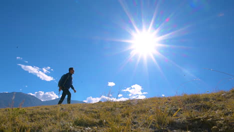 A-tourist-walks-under-the-Daylight-sunray-on-hills-of-Upper-Mustang-Nepal