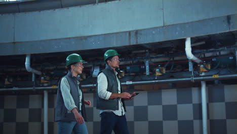 factory workers walking at dairy room. modern agricultural milking facility.