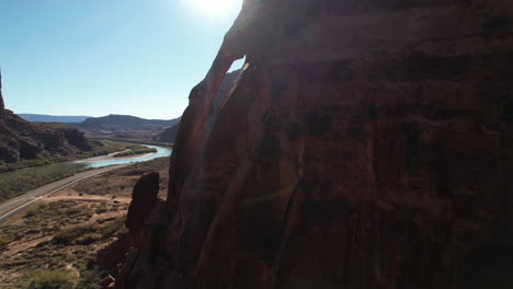 Aerial-View-of-Scenic-Sandstone-Formations-Above-Road-and-River,-Moab-Utah-USA