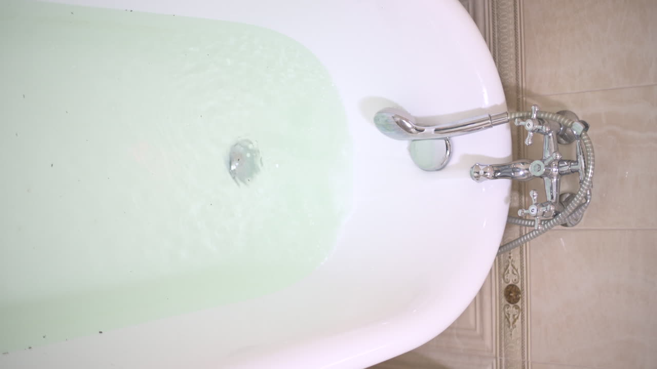 Water pouring in and filling the bathtub