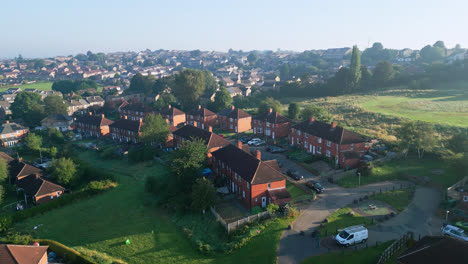 dewsbury moore council estate in the uk, as seen from a drone, spotlights red-brick houses and yorkshire's industrial landscape on a sunny morning