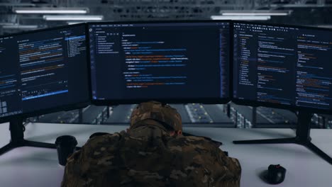 back view of tired asian military sleeping while write code with multiple computer screens in data center