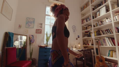 relaxed african-american girl dancing barefoot at home