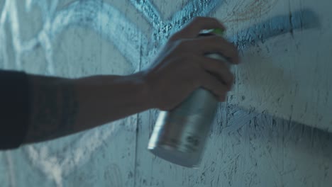 male artist using spray paint graffiti spraying lines