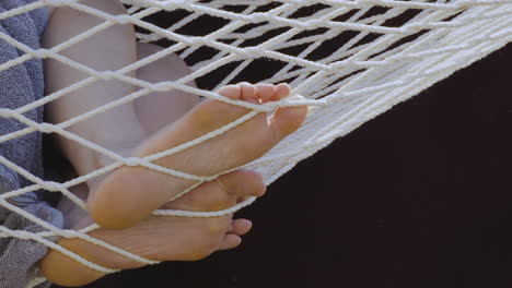 closeup of a woman’s feet on a hammock