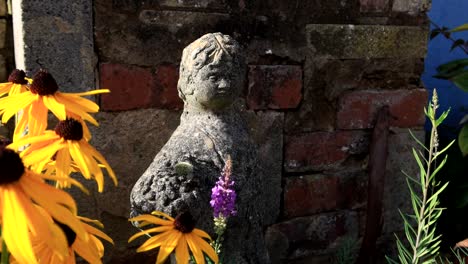 yellow flower and rustic statue