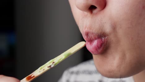 Close-up-of-a-person-enjoying-ice-cream,-detailed-shot-of-the-food-and-mouth