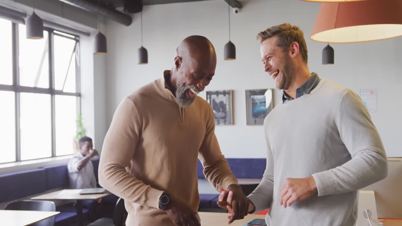 Portrait of happy diverse business people looking at camera at office