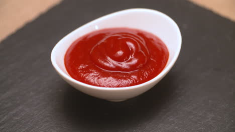 small serving dish filled with ketchup for dipping