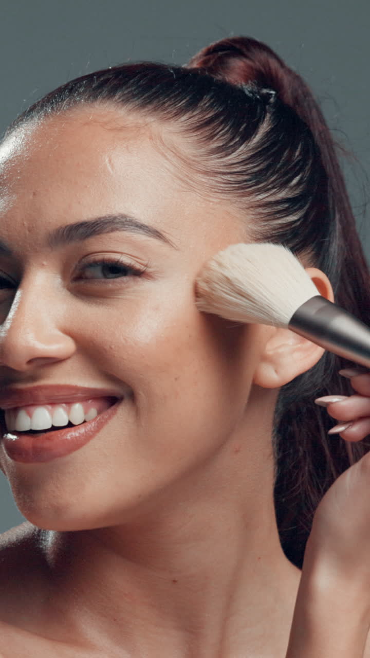 Smiling Young Woman Applying Makeup with a Brush