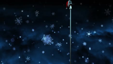 animation of snow falling over microphone with christmas hat on dark background