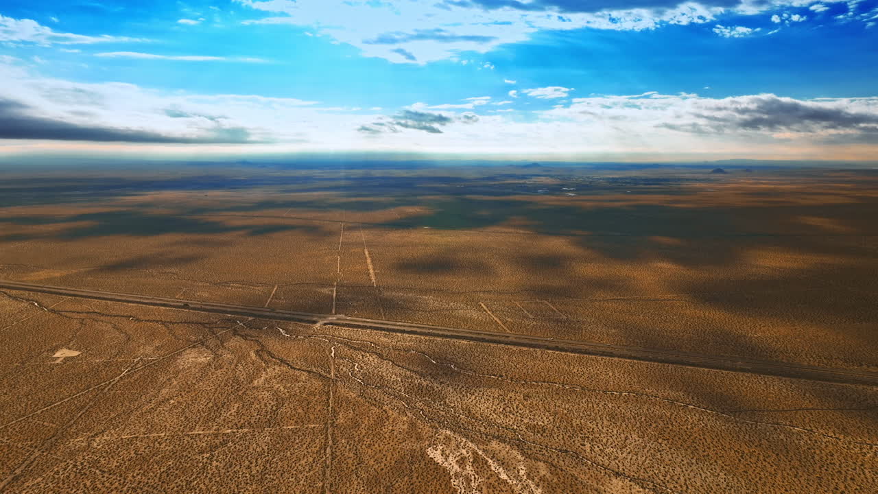 Endless scenery of desert in Nevada. Beautiful clouds throwing shadows on the land. Aerial view.