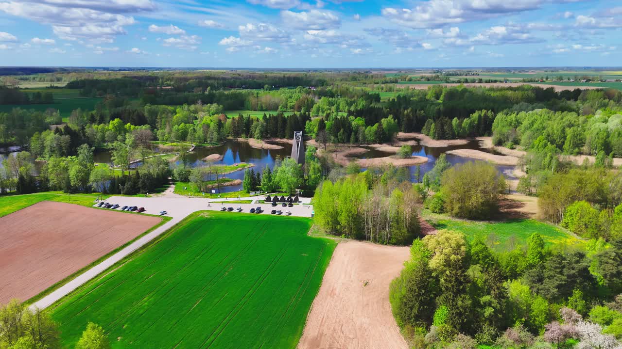 Aerial View Of Green Fields, Kirkilai Lakes and Observation Tower On A Sunny Day In Lithuania.