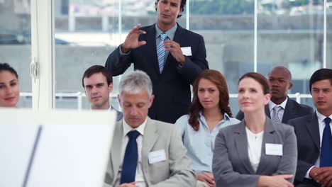 Businessman-stands-up-and-asks-question