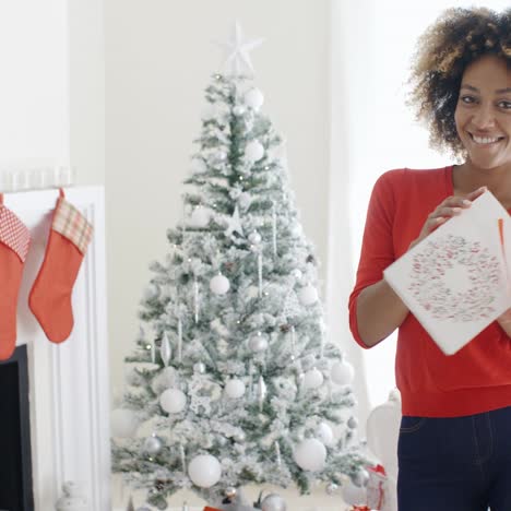 blissfully happy young woman with a xmas gift