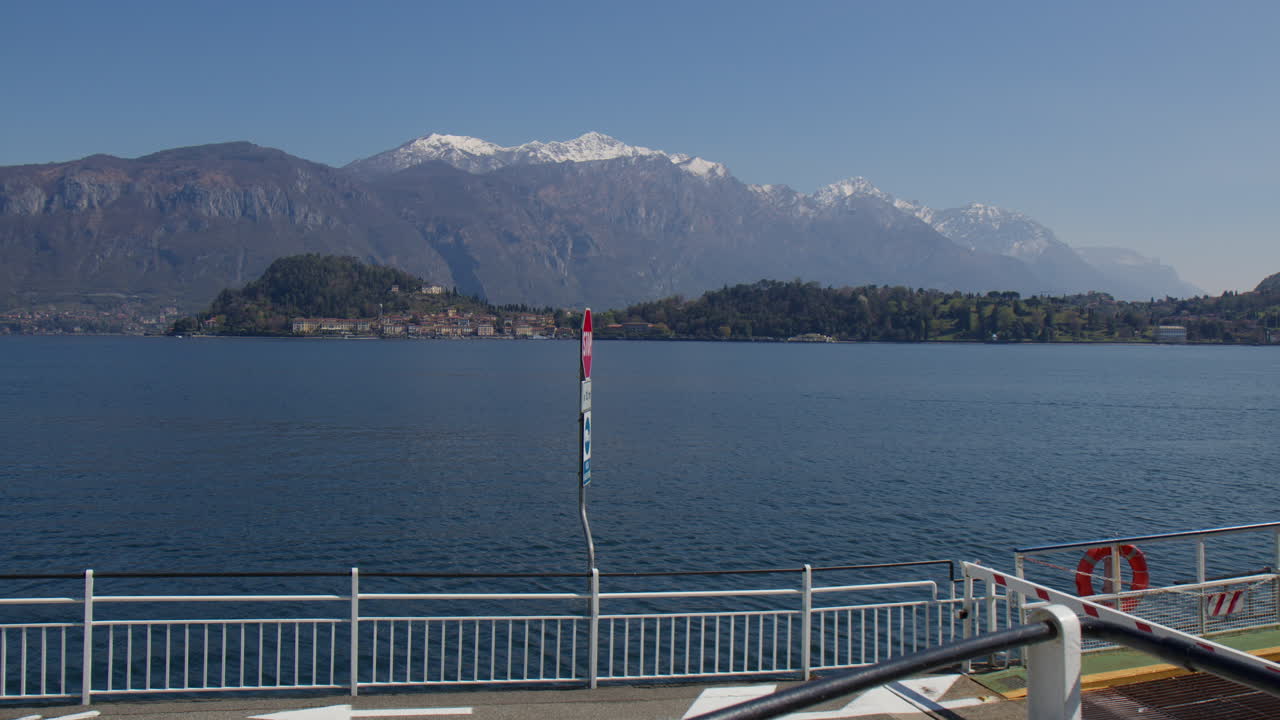 Lake Como And Snowcapped Mountains Seen From Pier At Ferry Terminal In Bellagio, Italy