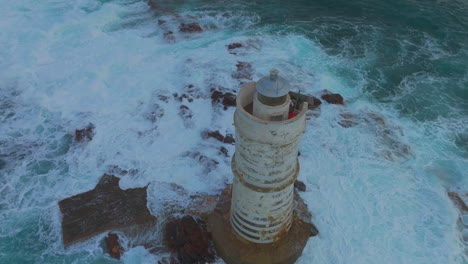 Nocturnal-Grandeur:-Sunset-at-the-Famous-Mangiabarche-Lighthouse-with-Waves-Crashing-in-Sardinia