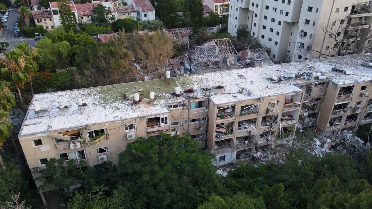 Nearly vertical drone circle shows rooftop and structural damage from missile strike in Tel Aviv