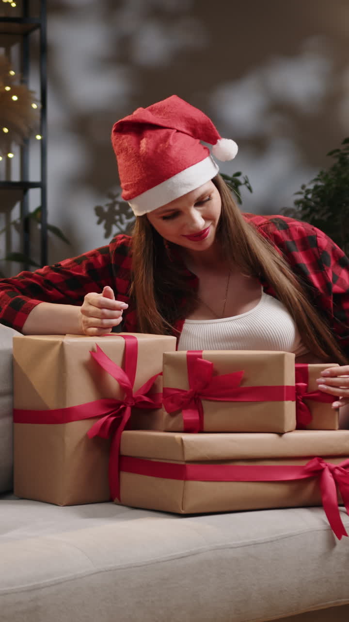 Pregnant woman opening christmas gifts