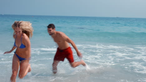 happy cute couple having fun at the beach