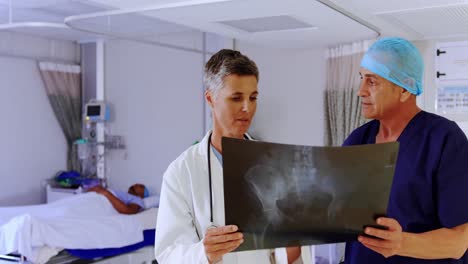 doctor-and-nurse-discussing-over-x-ray-report-4k