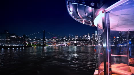 night river tour on board of the modern vehicle. beautiful skyline of new york and the manhattan bridge at backdrop