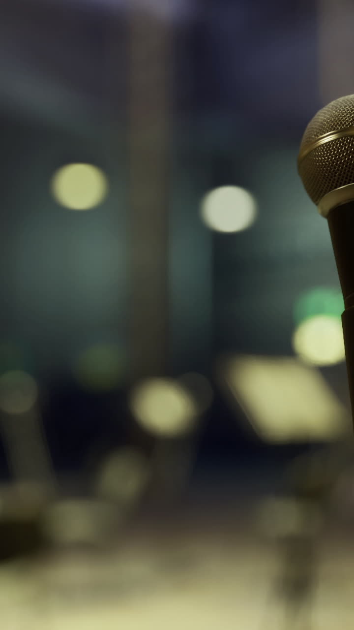 Microphone on stage with empty seats ready for a performance in a concert hall