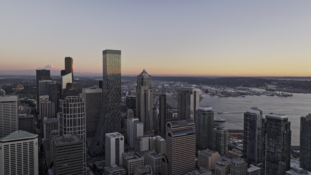 Seattle Washington Aerial v185 flyover Belltown thru downtown area, capturing towering skyscrapers in central business district, views of mountain at sunset - Shot with Mavic 3 Pro Cine - Oct 6th 2023