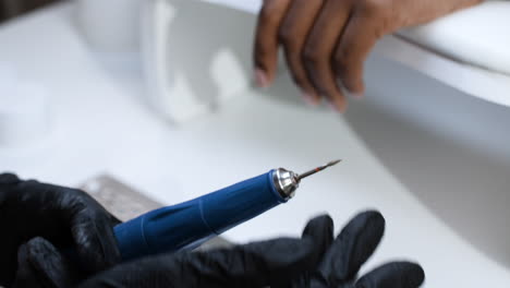 nail technician performing manicure