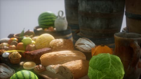 mesa de comida con barriles de vino y algunas frutas, verduras y pan