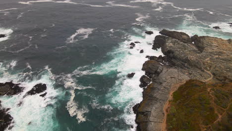 AERIAL---Rocky-shore-in-Zapallar,-Valparaiso,-Chile,-wide-circle-shot