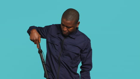 portrait of security agent removing baton from belt to secure assigned post