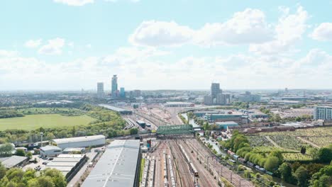 drone shot over train leaving london near wormwood scrubs acton