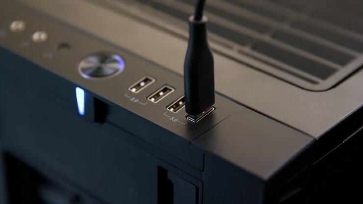 Man Plugs Multiple USB Cables into Desktop Computer