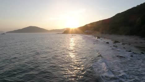 Reverse-drone-shot-of-a-beach-in-Hong-Kong