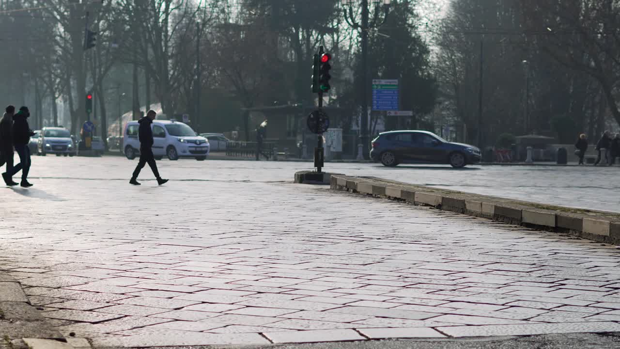 Pedestrians crossing busy avenue. Handheld
